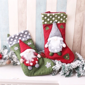 Detail of red and green Christmas stockings featuring 3D gnome figures and festive ornaments