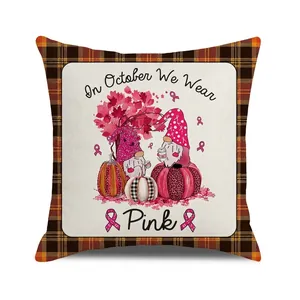 Close-up of October We Wear Pink gnome pumpkin throw pillow cover with check border