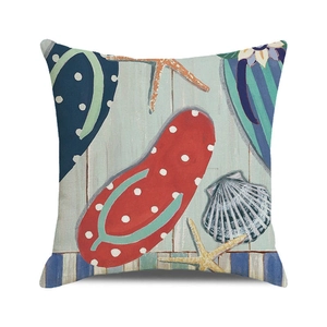 Detail of beach themed pillow cover with red flip flops, starfish and shell print