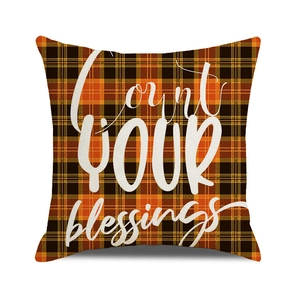 Detail of plaid pumpkin pillow cover with Count Your Blessings text and linen texture