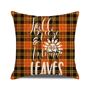 Detail of fall breeze typography on orange and black checkered pumpkin pillow cover