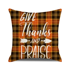 Close-up of Give Thanks text on orange and black plaid autumn decorative pillow case