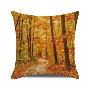 Close-up of autumn forest scenery print and texture on a square decorative pillow cover