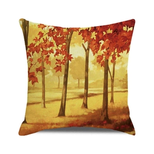 Close-up of square cushion cover featuring vibrant autumn forest leaves on linen fabric