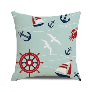 Detail of nautical cushion cover with lighthouse, anchor, and sailboat patterns on linen