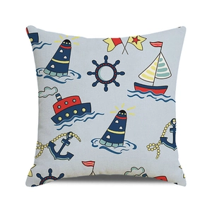 Close-up of nautical pillow cover showing fabric texture with lighthouse and sailboat patterns
