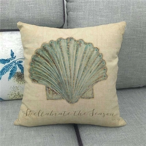 Detail of linen pillow cover with scallop print, embroidery and Shellabrate slogan