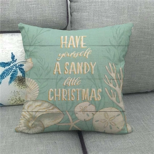 Detail of teal watercolor starfish and shell print on linen ocean theme cushion cover