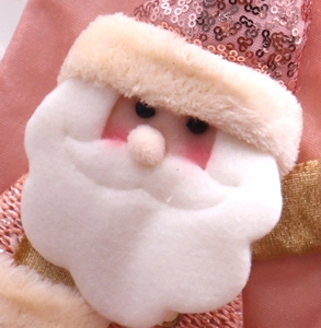 Close-up of Santa Claus hanging ornament with pink sequins and soft white plush details