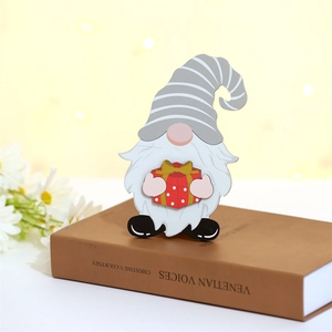 Détail d'un gnome de Noël en bois posé sur un livre dans un décor chaleureux et doux