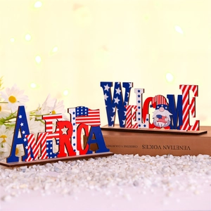 Detail of wooden America and Welcome gnome signs with stars and stripes on white stones
