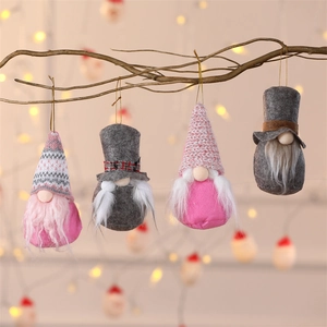 Set of four plush Christmas forest gnome pendants hanging on branches with warm bokeh lights