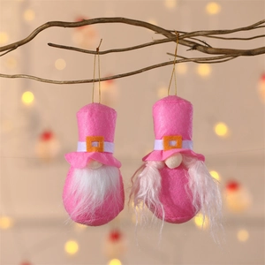 Detailed view of pink Christmas gnome ornaments with white beards hanging on tree branches