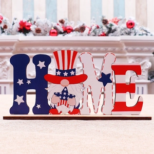 Detail of wooden HOME letters with patriotic American flag gnome figure on a dark base