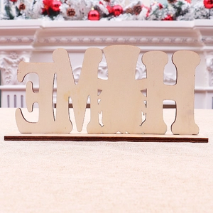 Macro view of wooden HOME letters on a dark base with festive holiday mantel decor
