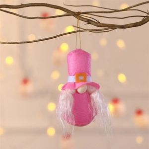 Pink Christmas gnome ornament with white beard and orange buckle hanging on branch
