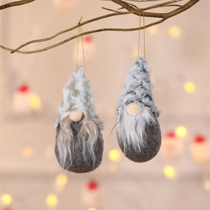 Close-up of handmade Christmas forest gnome plush ornaments with long fur and knit hats
