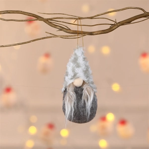 Detailed close-up of a Christmas gnome ornament with white felt hat and long plush beard