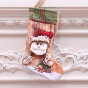Classic Christmas stocking with 3D Santa Claus applique and plaid trim on a white wall