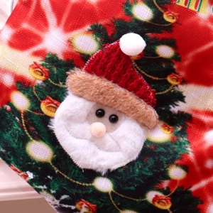 Detailed view of 3D Santa Claus applique and festive patterns on a large LED Christmas sock