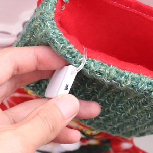 Detail of LED light switch and battery compartment inside a festive Christmas stocking
