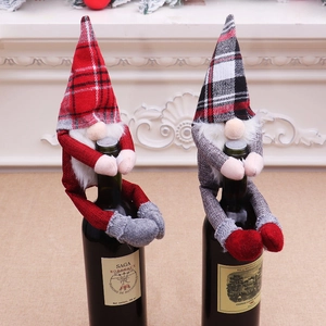 Detail of Christmas gnome wine bottle covers with plaid hats and long faux fur beards