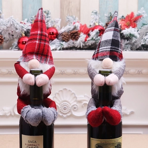 Detail of Christmas gnome wine bottle covers with red and black checkered knit hats
