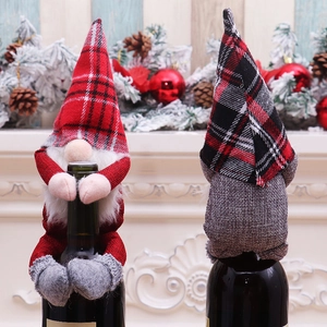 Detail of Christmas gnome wine bottle covers with knitted hats and plush beards