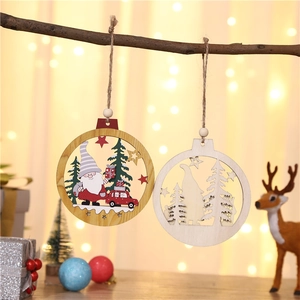 Detail of wooden Christmas ornaments with Santa and Xmas truck hanging on a branch