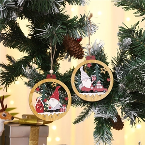 Rustic wood Christmas gnome ornaments hanging on pine branches with festive bokeh lights