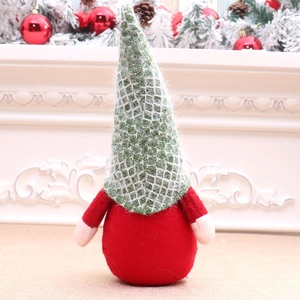 Detailed view of a plush Christmas gnome figurine with green knitted hat and red body