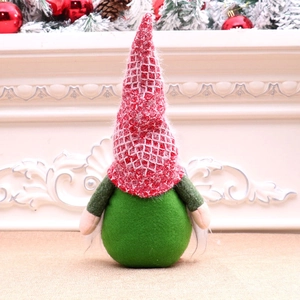 Detailed view of a Christmas gnome doll with a red plaid hat by a festive fireplace