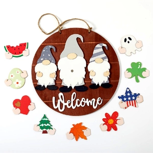 Detail view of round wooden welcome sign with gnome motifs and 10 seasonal icons
