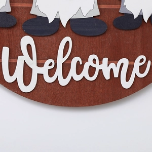 Detail of wooden welcome sign with gnome graphics and white artistic font texture