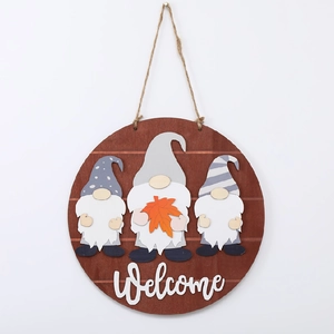Close-up of rustic wooden welcome sign featuring 3D fall gnomes and maple leaf detail