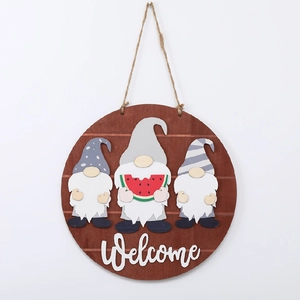 Detail of wooden welcome sign with seasonal gnome figurines and watermelon decor
