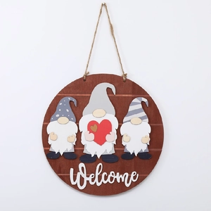 Detail of round wooden welcome sign with three 3D gnomes and a red heart decoration