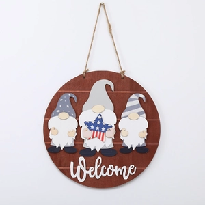 Detail of wooden welcome sign with three gnomes and patriotic star on white background