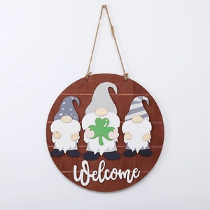 Close-up of St. Patrick's Day wooden welcome sign with gnomes and green clover detail