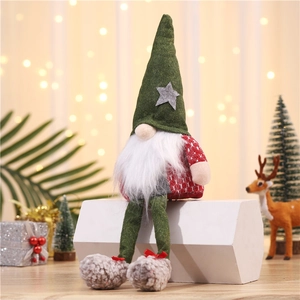 Close-up of a festive long-legged Christmas gnome with glowing hat and plush knitted texture