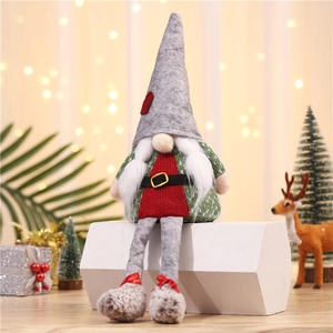 Detailed view of a glowing Christmas gnome plush with grey legs on a festive display