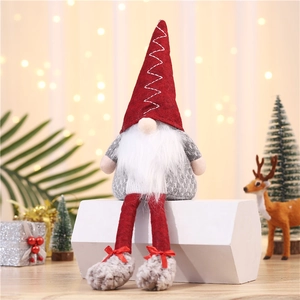 Close-up of a festive long-legged Christmas gnome with glowing nose and red pointed hat