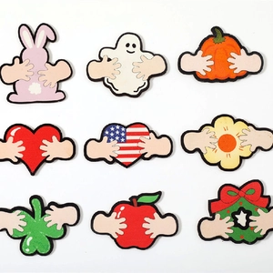 Detail view of nine seasonal embroidered patches including bunny, pumpkin and heart motifs