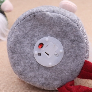 Detail view of the Christmas gnome base featuring the ON/OFF switch and battery compartment