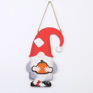 Detail of wooden Halloween gnome decoration with red hat and orange pumpkin on hemp rope