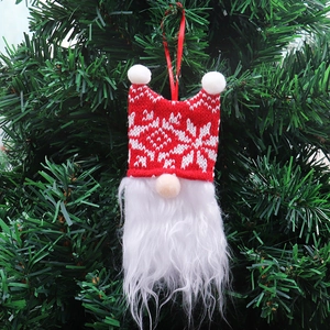 Detail of a Christmas gnome hanging ornament with red snowflake knit hat and white faux beard