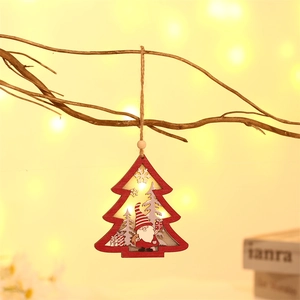Detail of wooden Christmas tree gnome ornament with warm LED light and hanging hemp rope