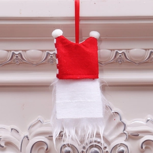 Detailed view of handmade Christmas gnome ornament with red felt hat and white faux fur beard