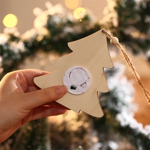 Close-up of wooden Christmas tree pendant back showing LED battery compartment and switch