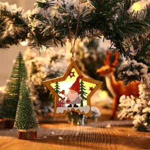 Close-up of lighted star-shaped wooden ornament with gnome and Christmas tree details